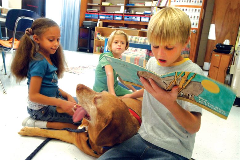 students reading a book together